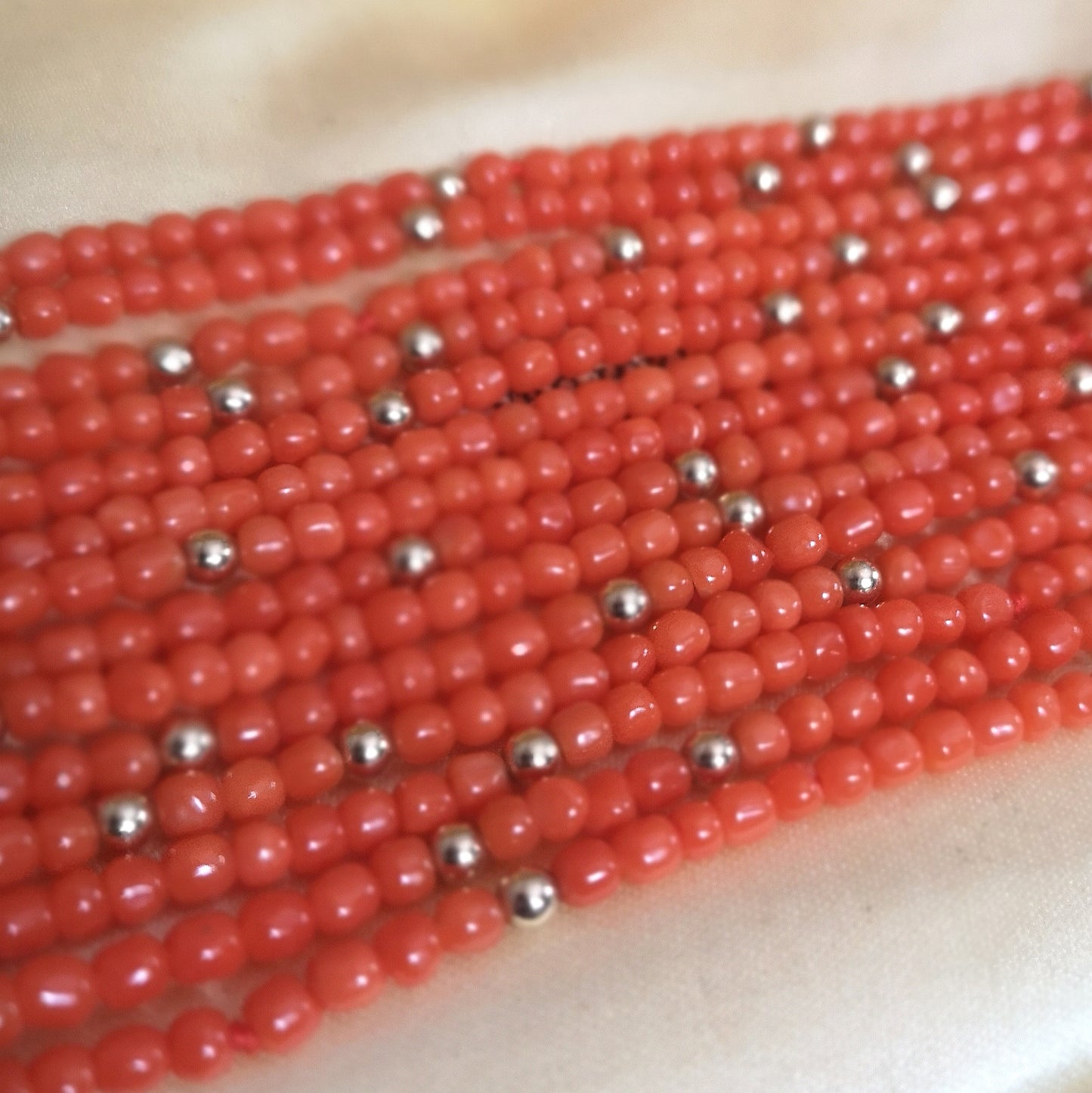 The versatile coral and gold bead 7-strand layering necklace