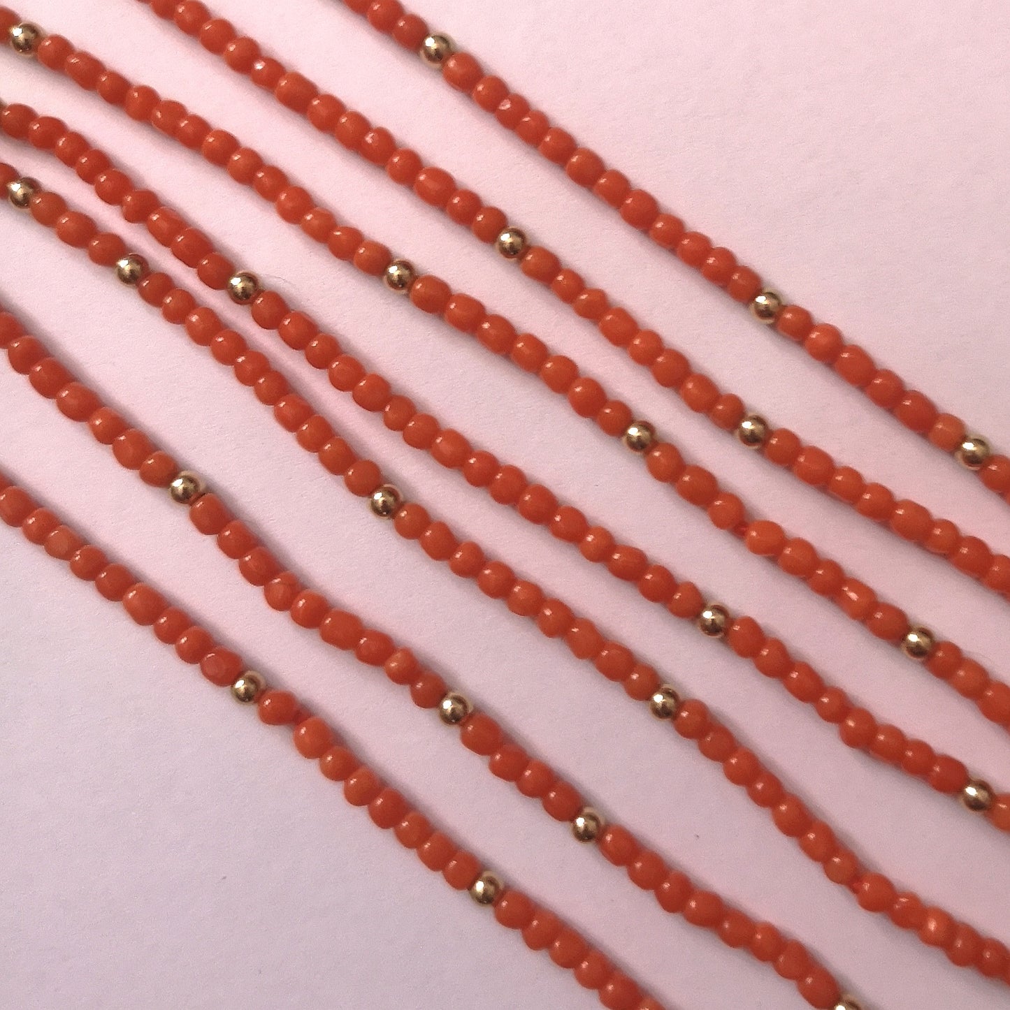 The versatile coral and gold bead 7-strand layering necklace
